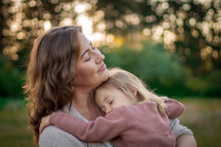 Mother warmly hugging her daughter during a Lifestyle Family Photography session