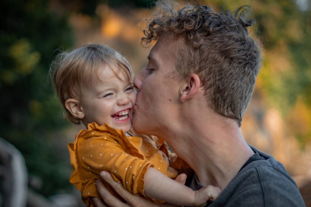 dad playing with baby beach family photoshoot boost kids self-esteem victoria bc photography