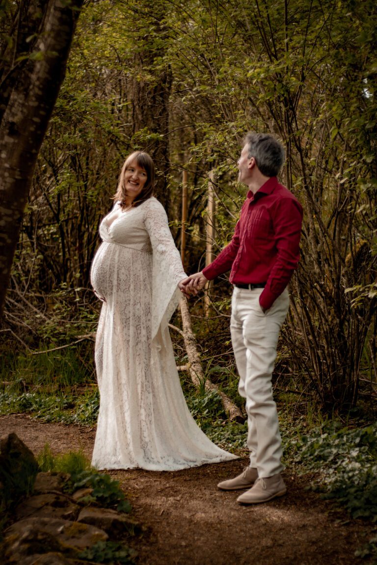 romantic couple with pregnant woman walking along a forest trail maternity photoshoot at horth hill regional park north saanich bc with alyssa orrego photography